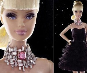 The custom-made doll wears three carats of white diamonds set around a one-carat, squ...