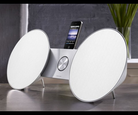 The new iPad BeoSound 8 Speaker Dock cradles your Apple gadgets �in between two large, color-customizable conical speakers each with a pair of drivers and amplifiers at an unmentioned power level. Acousting tuning comes over from the Danish company�s other speakers and, with a switch, alters the sound output to match the properties of the room
