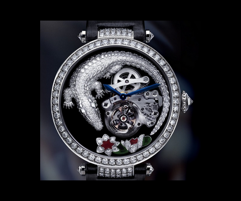 
The Crocodile on the black dial is curled around, almost protecting, a flying tourbillon. Sharing the dial with the croc, are two lotus flower resting at the 6 'o'clock position. Cartier's distinctive blued steel hands display the time above Cartier's in house mechanical manually wound movement Calibre 9458 MC which is placed off center to make space for the croc