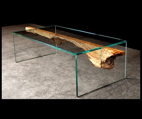 John Houshmand�s latest furniture collection, Shazam, is a juxtaposition of sleek Lucite or glass and organic wood. The artist and owner of the SoHo and LA-based galleries bearing his name applies thinly sliced layers of wood to glass or Lucite to create what he calls his signature microslab. �I use wood as a graphic element rather than a furniture element,� he explained. He describes his wood treatment as a painterly finish because the slices reveal the wood�s inherent ring patterns almost like a brush stroke. 